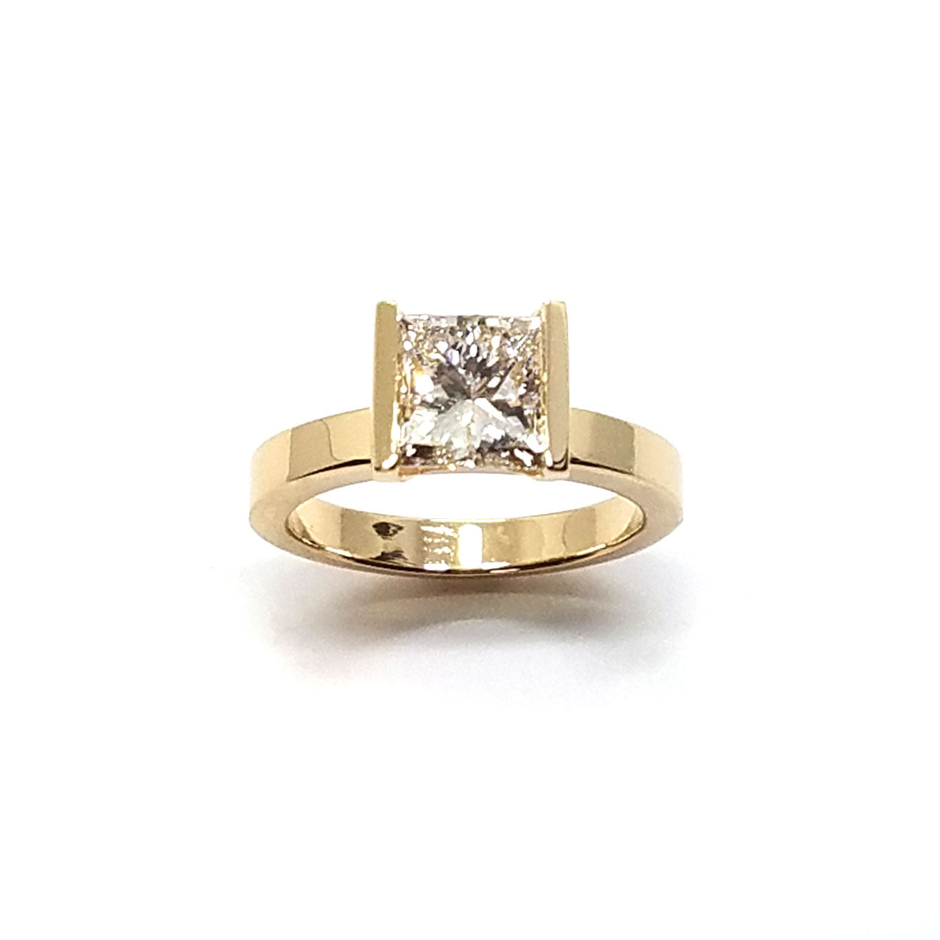 A modern bar-set solitaire with a single princess cut diamond