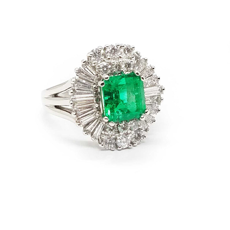 A ballerina style ring with diamond baguettes and an emerald center