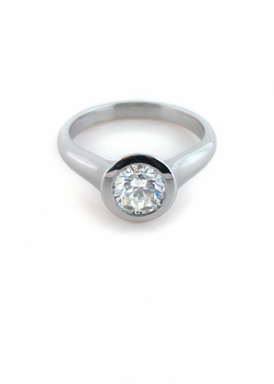 Custom made modern bezel diamond solitaire ring in Platinum