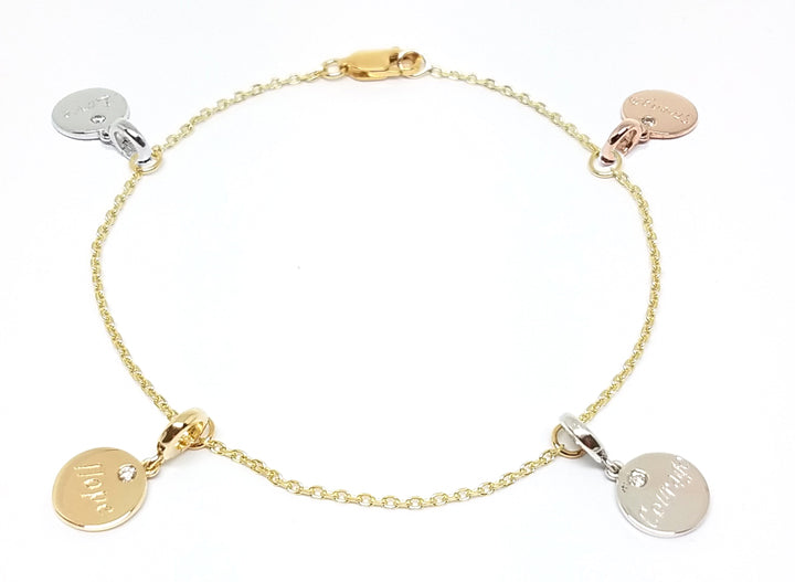 A custom made gold bracelet with engraved diamond studded detachable charms in  platinum, rose, yellow and white gold.