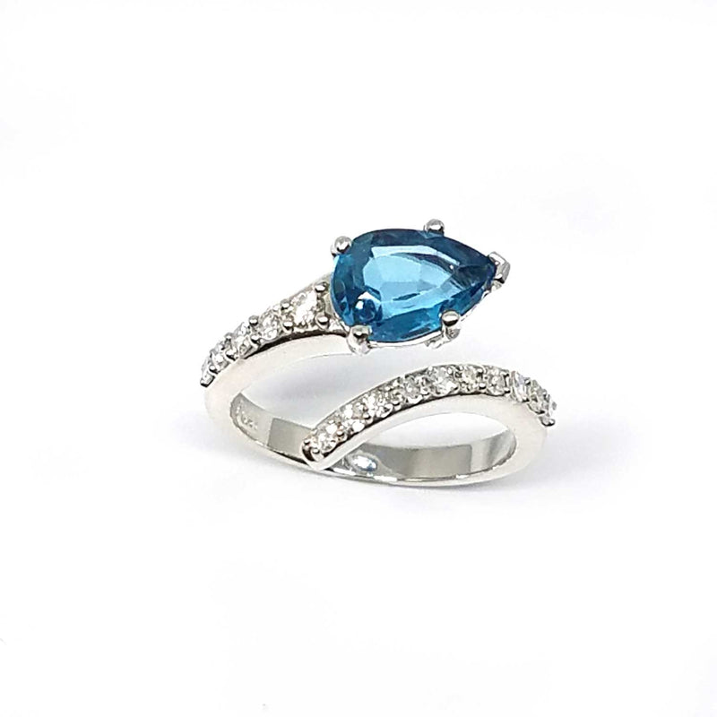 A bypass ring with a London Blue Topaz and diamonds