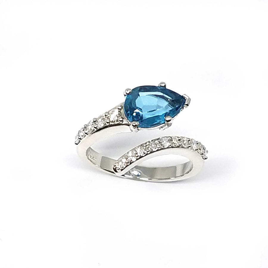 A bypass ring with a London Blue Topaz and diamonds
