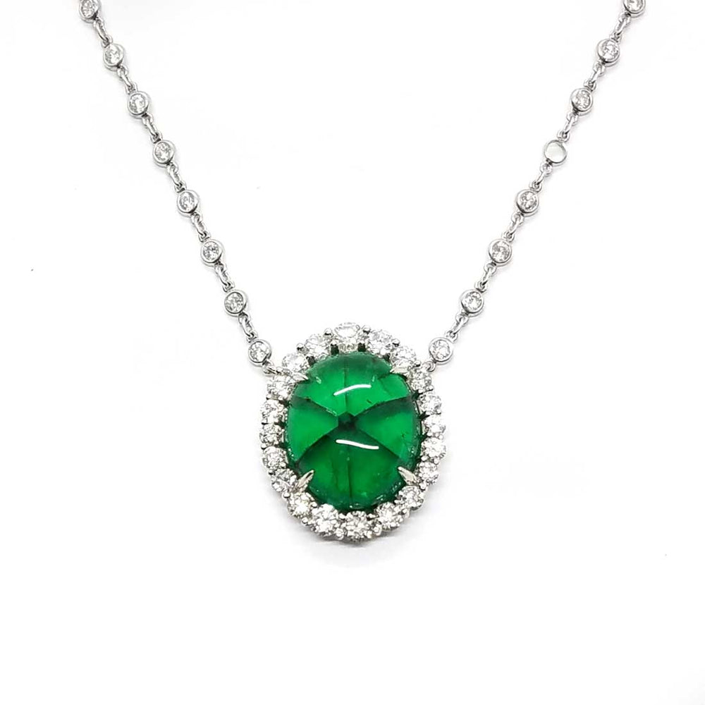 A rare Trapiche Emerald with a diamond halo and diamond chain