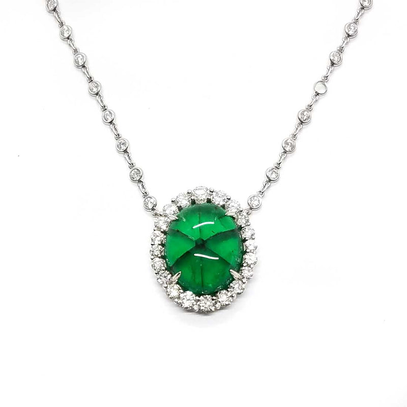 A rare Trapiche Emerald with a diamond halo and diamond chain