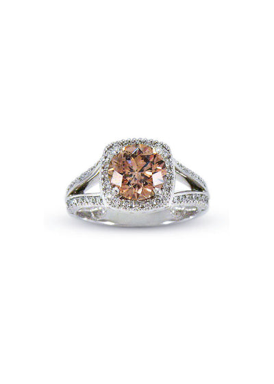 A platinum split-shank ring with a chocolate diamond in a white diamond halo