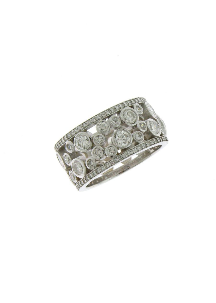 A custom made platinum and diamond 3-stone ring with a dark blue sapphire and 2 oval diamonds on the side.